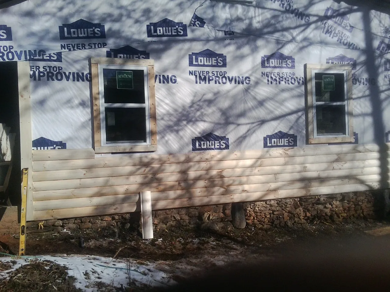 House wrap and new log siding going up on an exterior wall in Hatboro