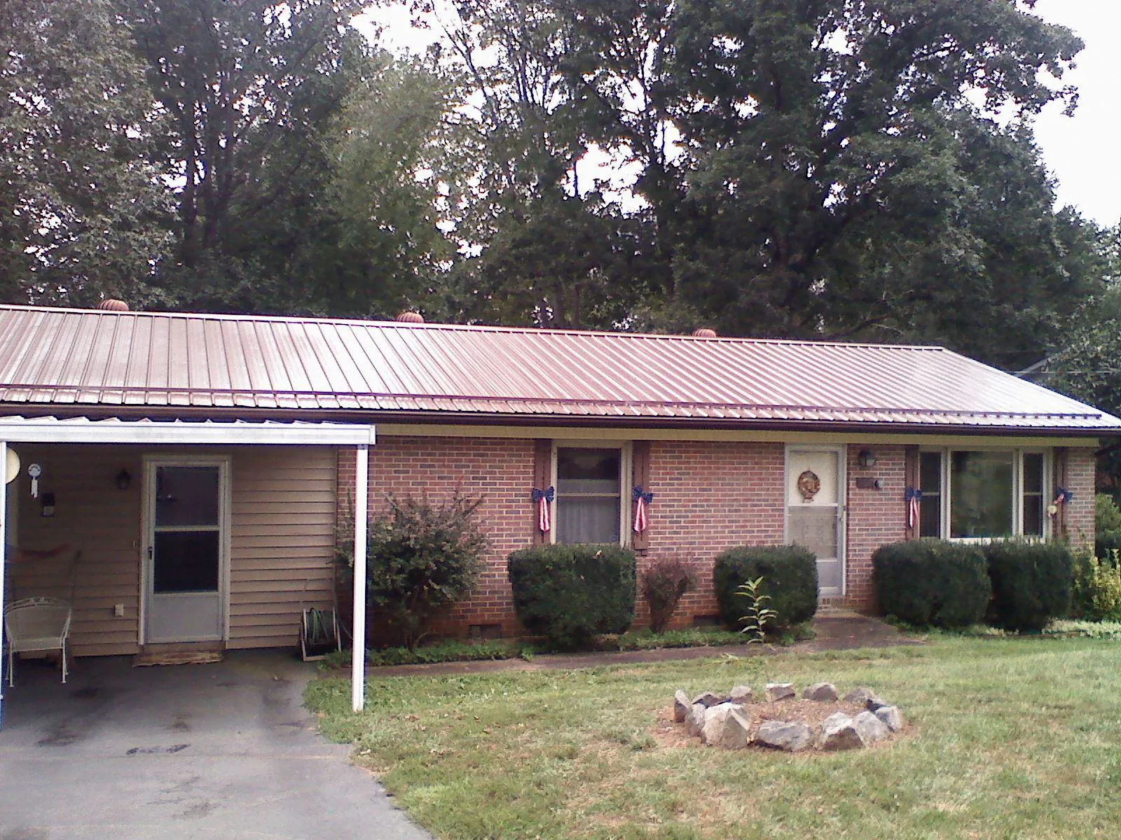 Bronze metal roof and carport on a brick ranch home — Roof Repair work by our crew in Hatboro